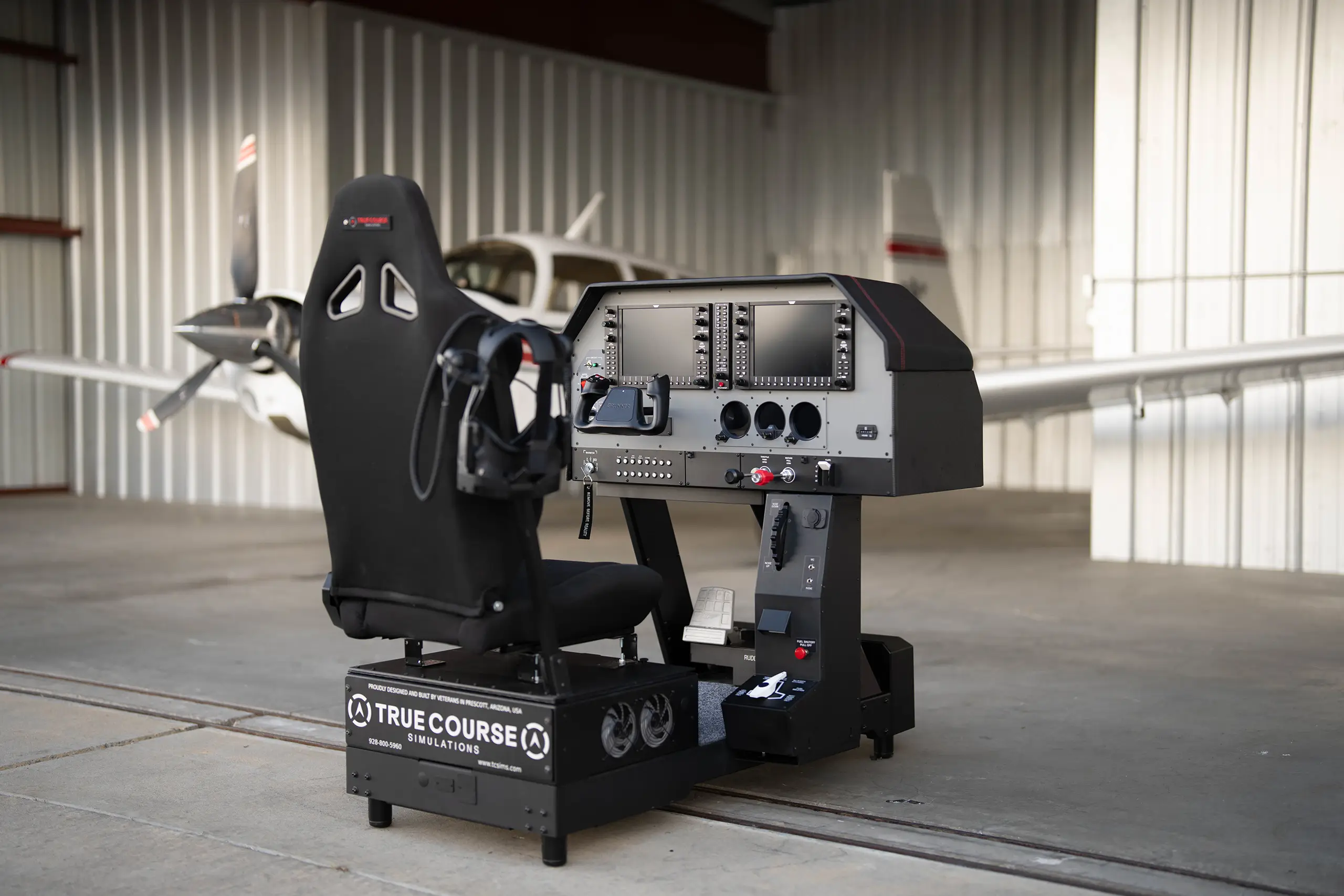 Professional Pilot Flight Training Facility Prescott Arizona TCS Immersive flight simulator for VR/MR flight training in a Prescott Valley hangar with a single-engine aircraft in the background