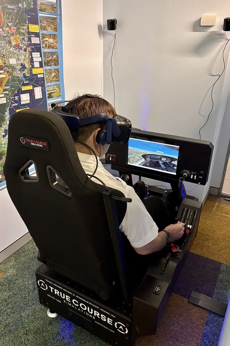 unsw-da40-vr-flight-simulator-true-course-simulations-sydney. Student using a True Course Simulations DA40 VR immersive trainer at UNSW Aviation in Sydney, with G1000 display and flight controls visible.